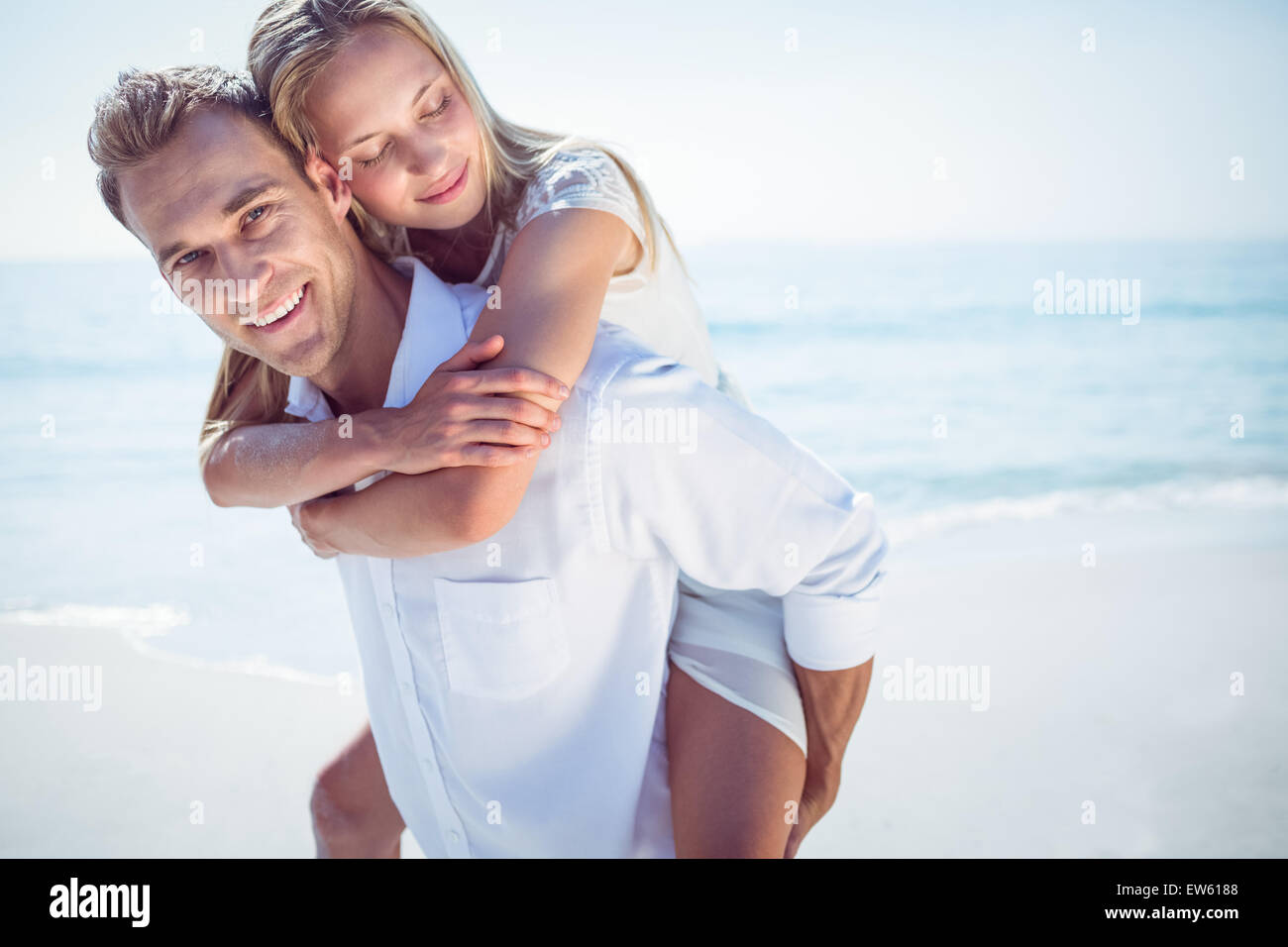 Happy couple having fun on the beach Stock Photo - Alamy