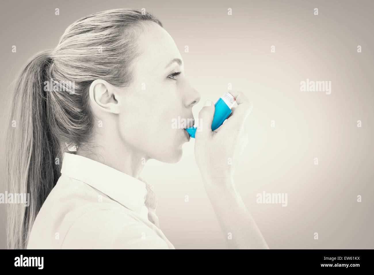 Pretty Inhaler Composite image of pretty blonde using an asthma inhaler Stock Photo ...