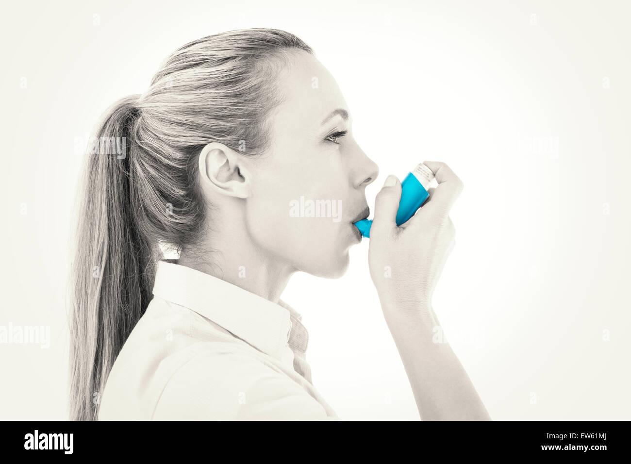 Pretty blonde using an asthma inhaler Stock Photo - Alamy