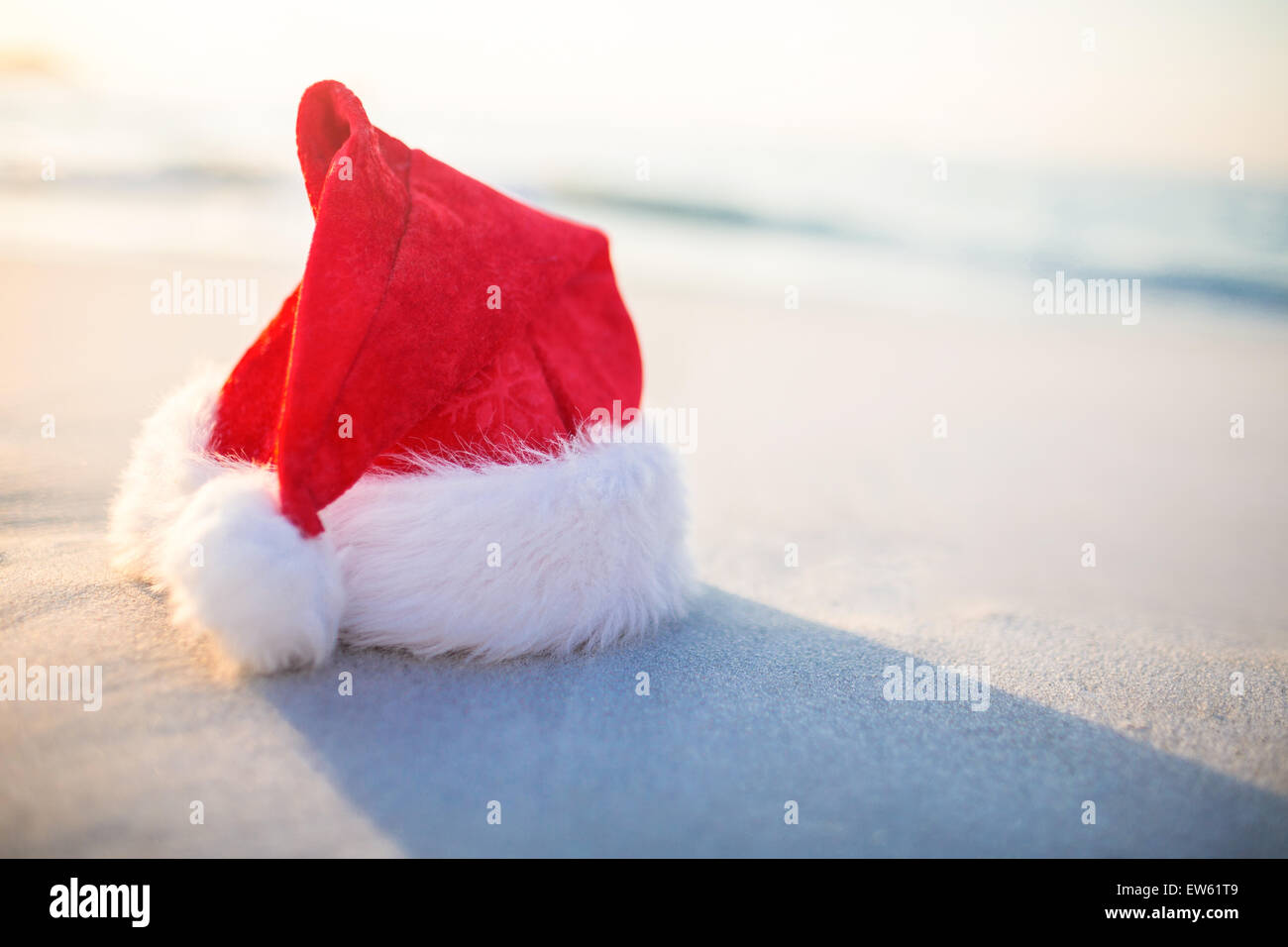 Santa hat on the beach Stock Photo - Alamy