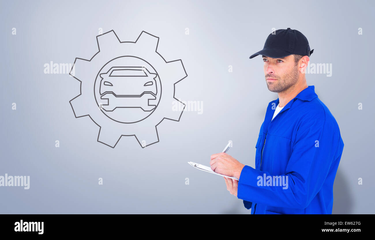 Composite image of mechanic in blue overalls writing on clipboard Stock Photo