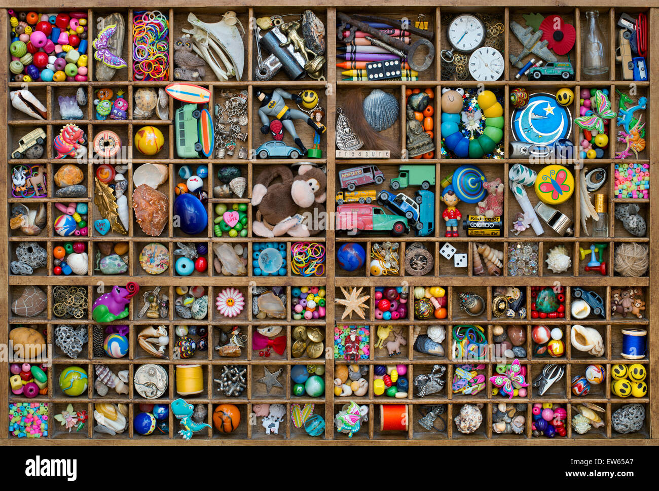 Wooden tray of childrens toys and a treasure trove of small collectable items Stock Photo