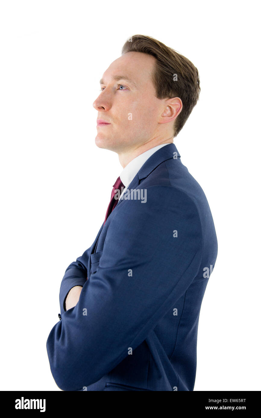 Thoughtful businessman looking away with arms crossed Stock Photo - Alamy