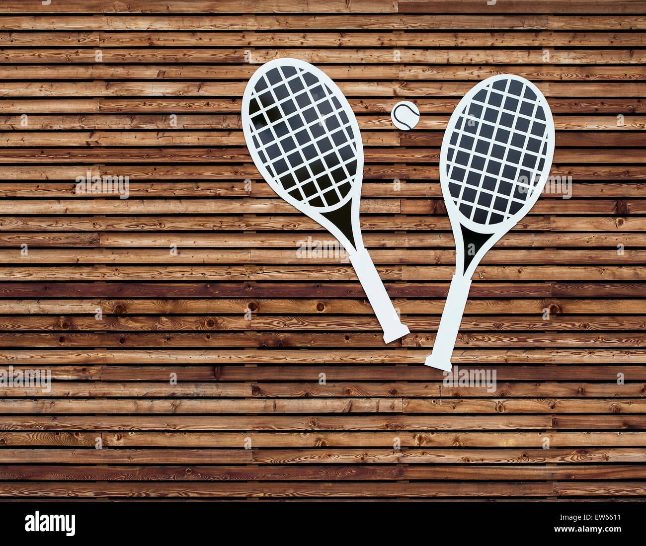 Tennis Rackets on a wooden wall. Stock Photo