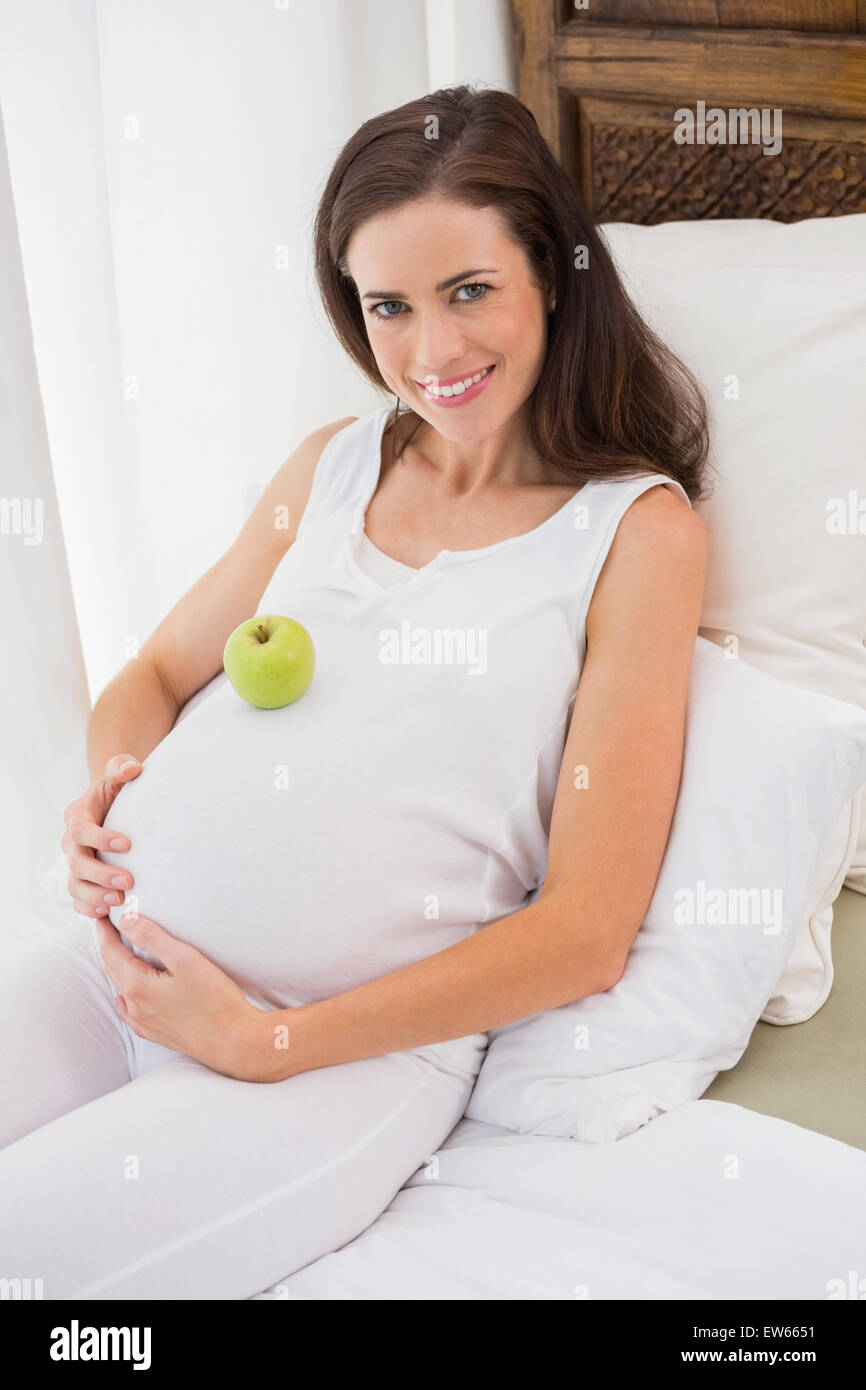 Happy pregnancy with an apple on his belly Stock Photo Alamy