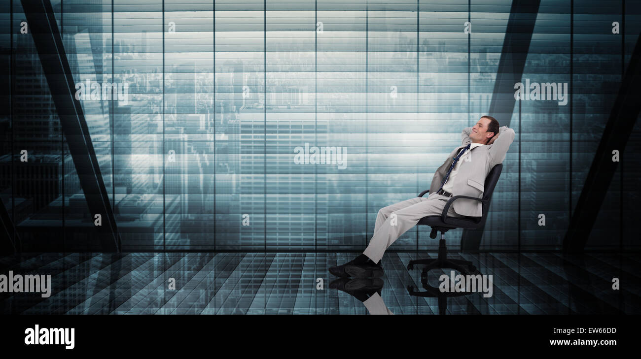 Composite image of businessman relaxing in swivel chair Stock Photo