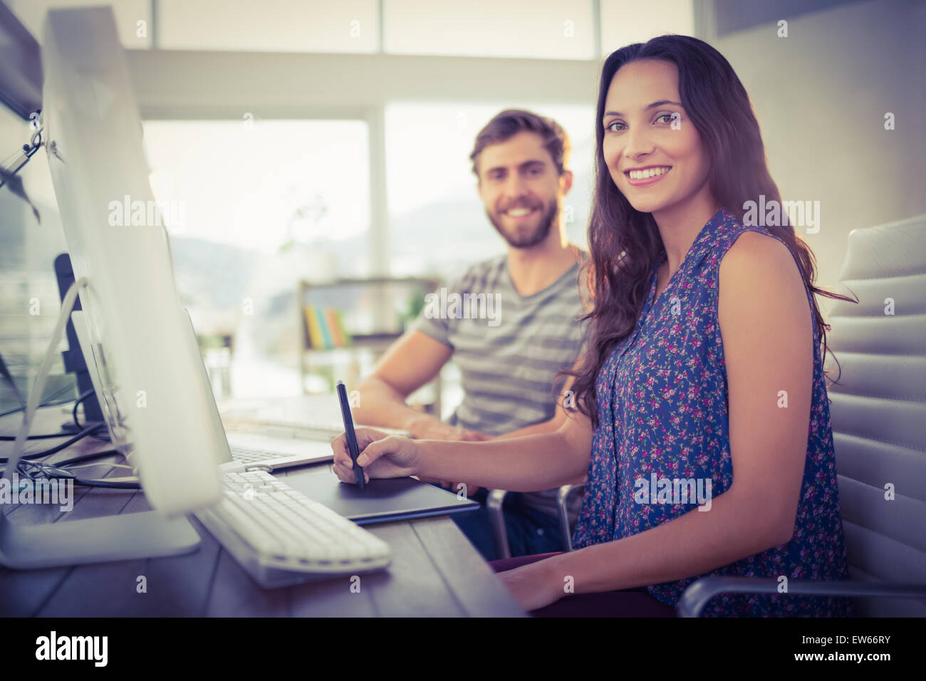 Happy business colleagues smiling at the camera Stock Photo - Alamy