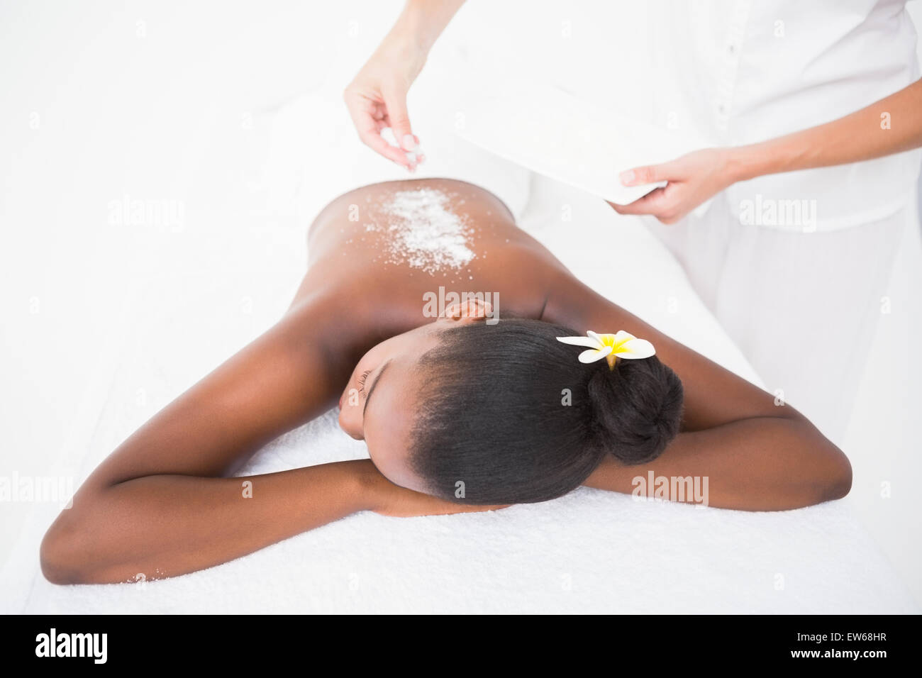 Pretty woman enjoying an exfoliation massage Stock Photo