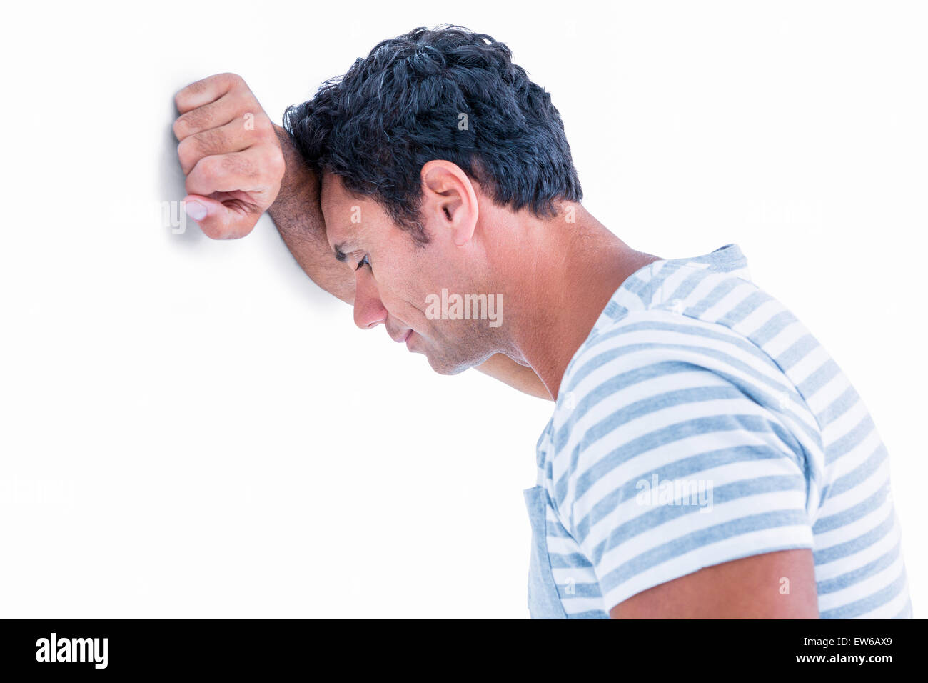 Sad man leaning his head against a wall Stock Photo - Alamy