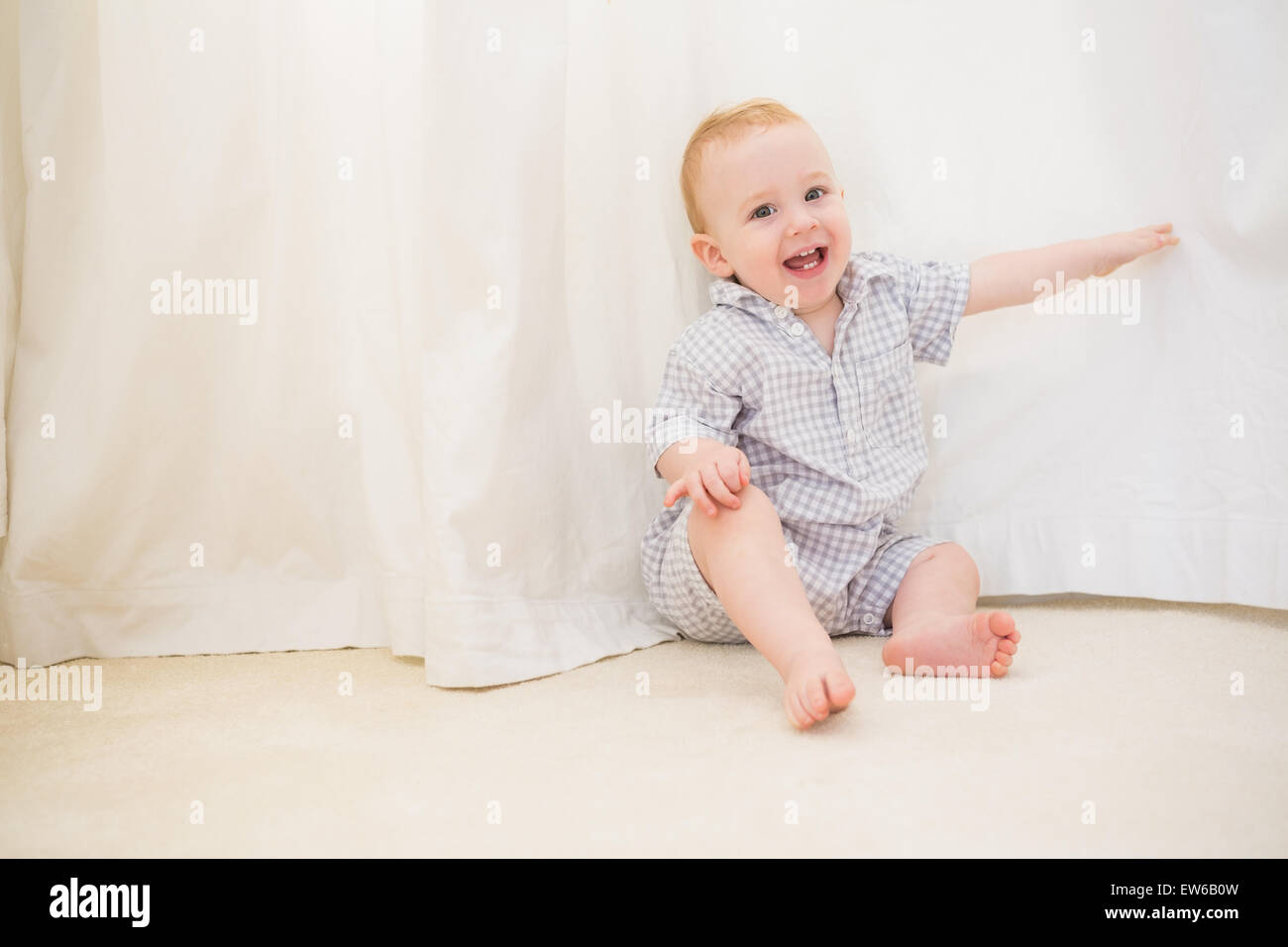 Baby boy sitting on floor hi-res stock photography and images - Alamy