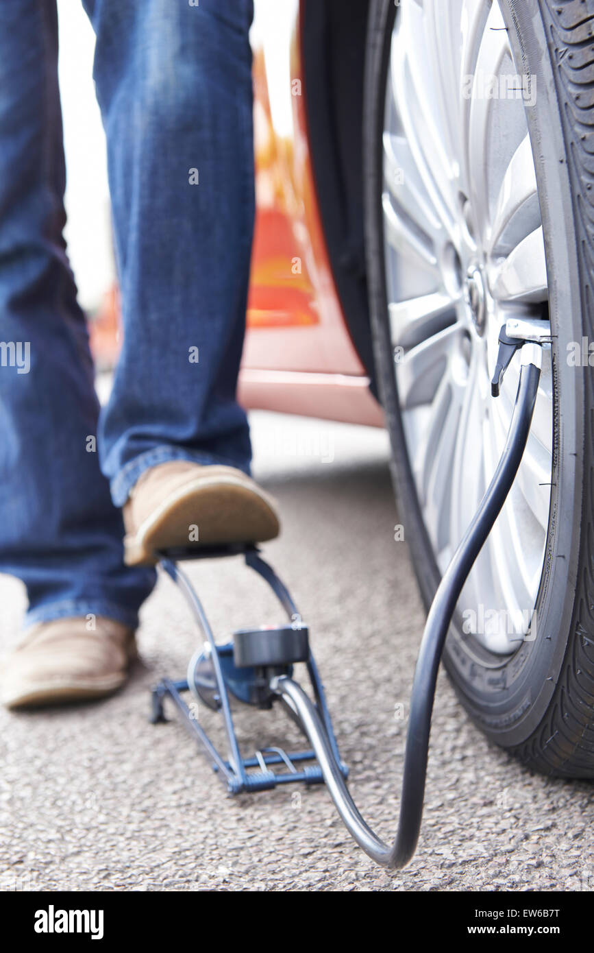 Close Up Of Man Inflating Car Tyre With Foot Pump Stock Photo Alamy