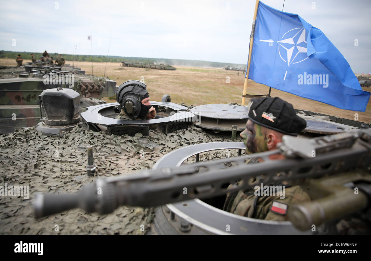 Sagan, Poland. 18th June, 2015. Polish soldiers monitor the area from the hatch of a tank during the first 'Noble Jump' maneuvers following the redeployment of NATO troops on a military training ground near Sagan, Poland, 18 June 2015. The NATO Very High Stock Photo
