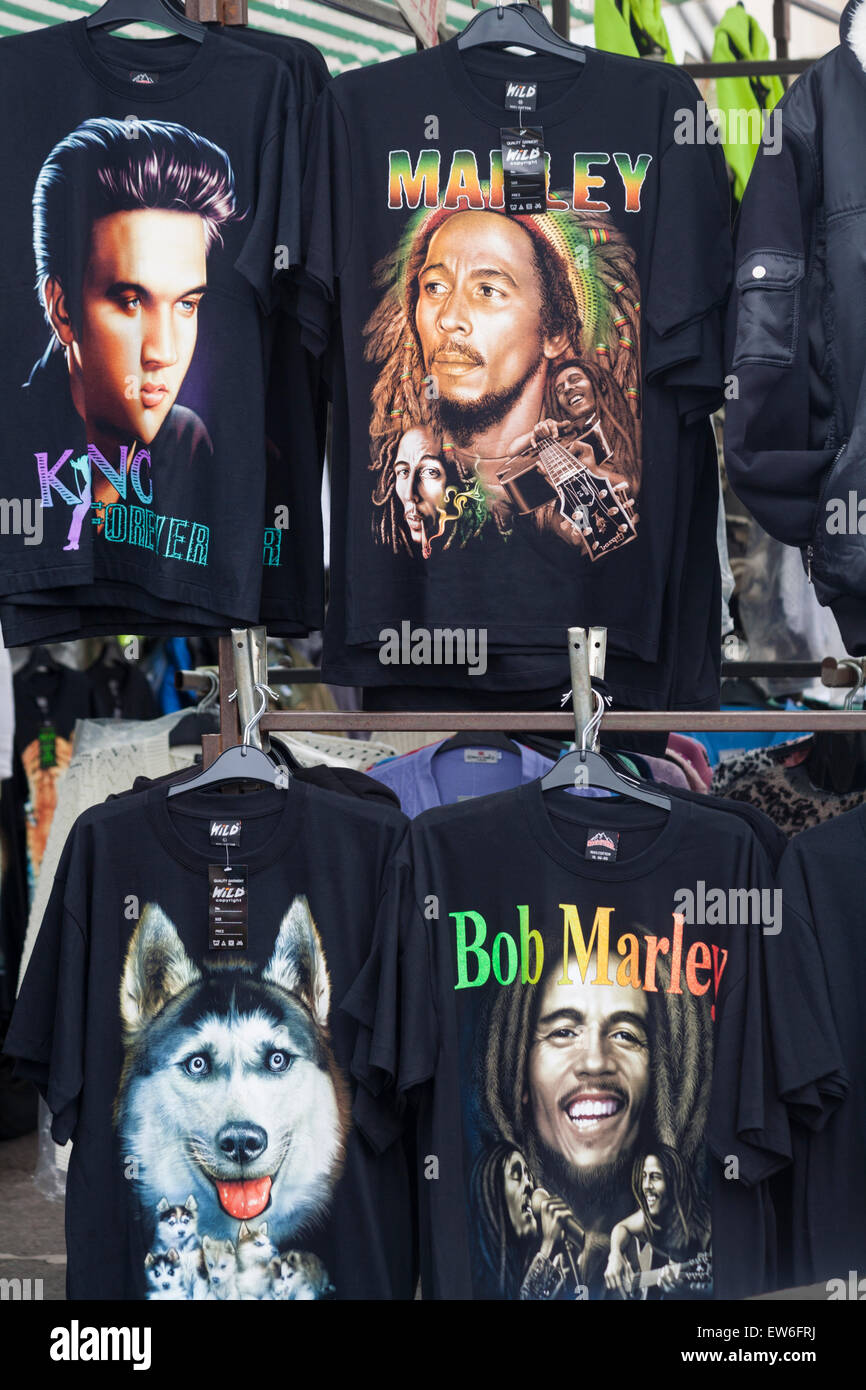 t-shirts for sale on market stall, including Bob Marley and Elvis Presley in Dorchester, Dorset, UK in June - tee shirts, t shirts, t-shirt tee shirt Stock Photo