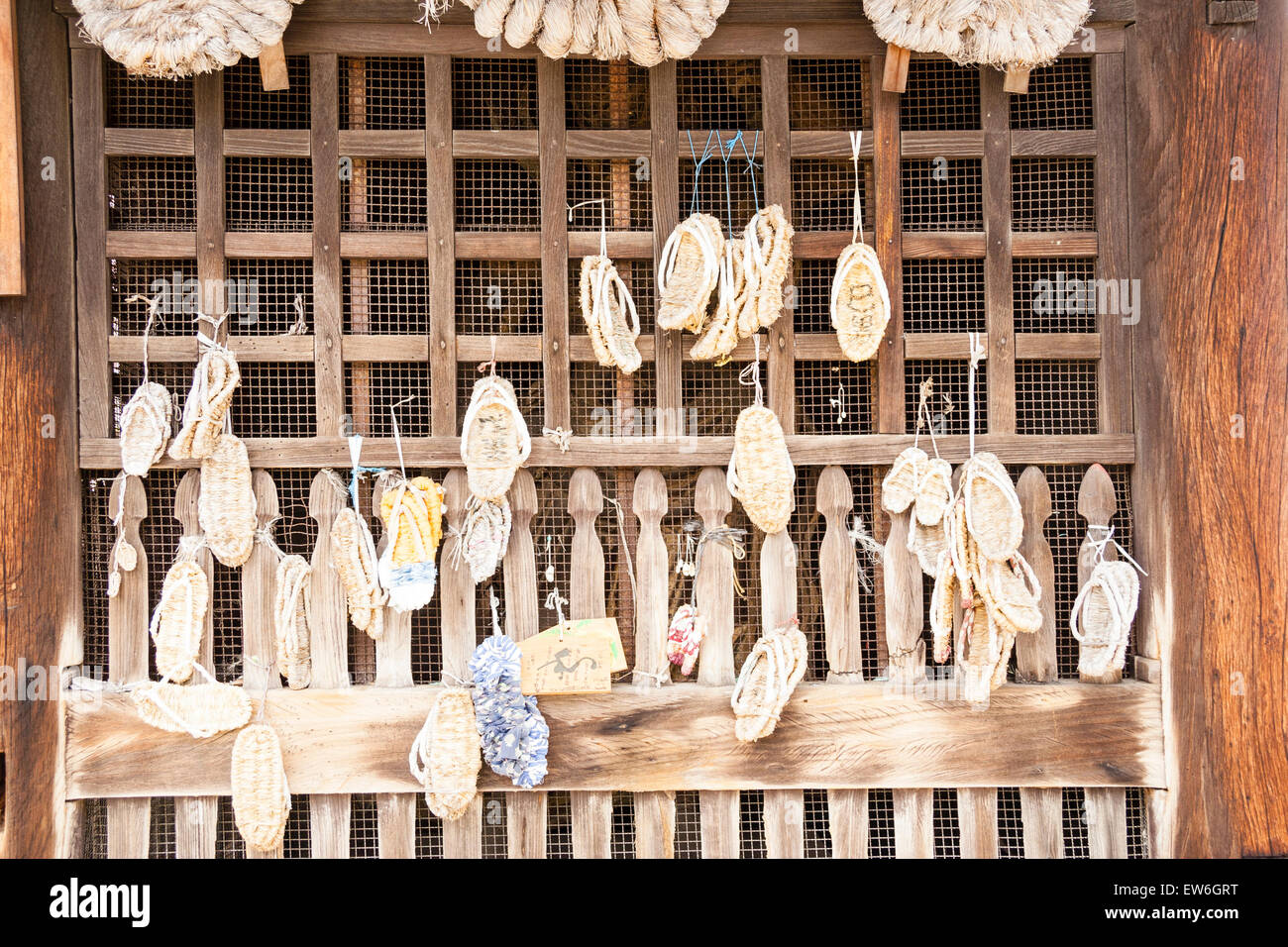 Japan, Onomichi, Saikokuji Temple. Many small straw sandals, owaraji, waraji, hanging from the wooden Deva gate. Traditionally worn by pilgrims. Stock Photo