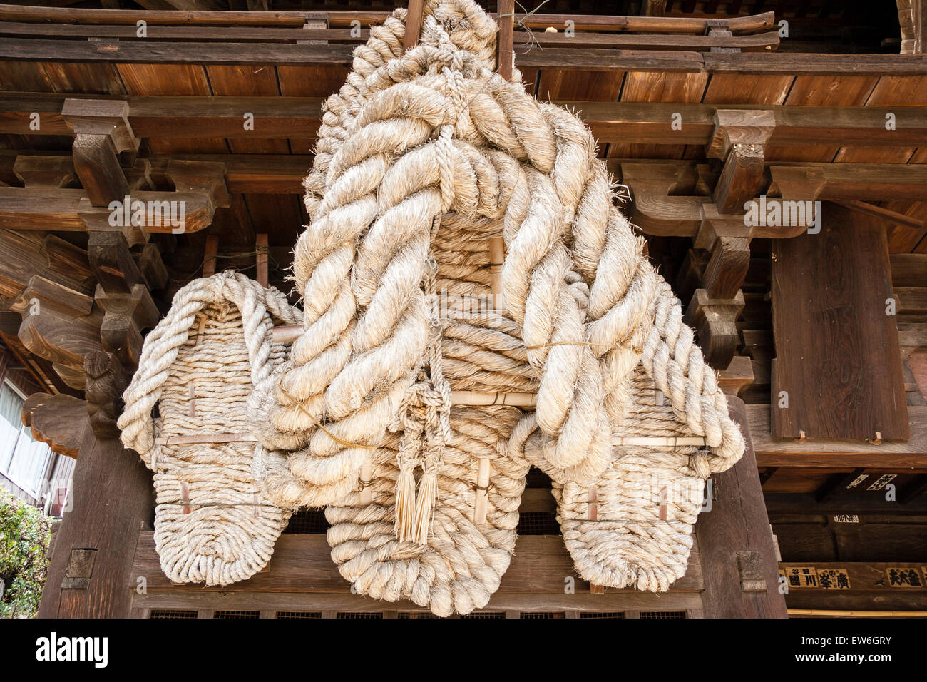 Japan, Onomichi, Saikokuji Temple. Massive pilgrims straw sandals, owaraji, AKA waraji, hanging from the wooden Deva gate. Stock Photo