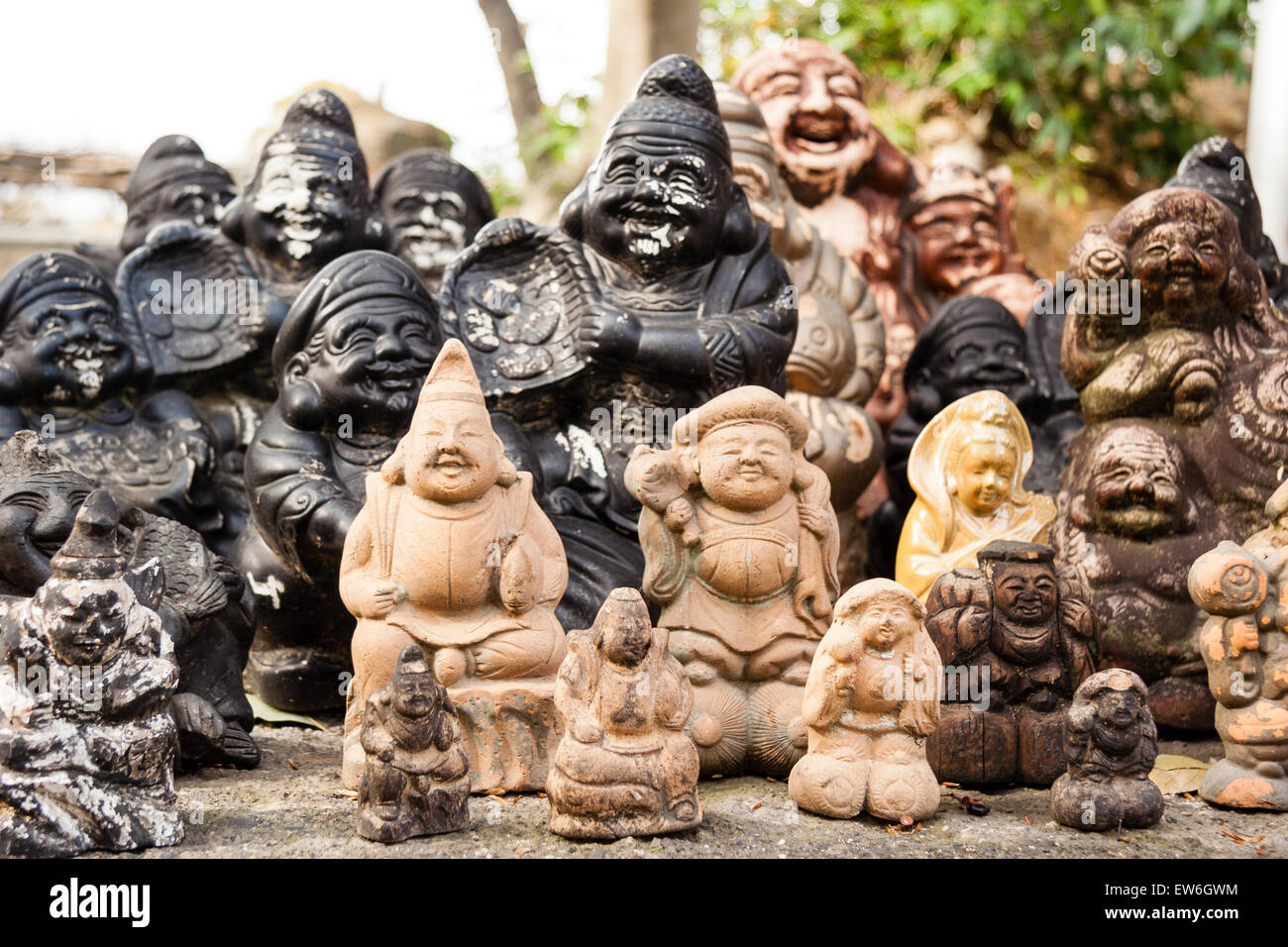 Japan, Kurashiki. Achi-jinja. Small statues of Shichifukujin, some of the the Japanese seven gods of happiness and good fortune arranged in group. Stock Photo
