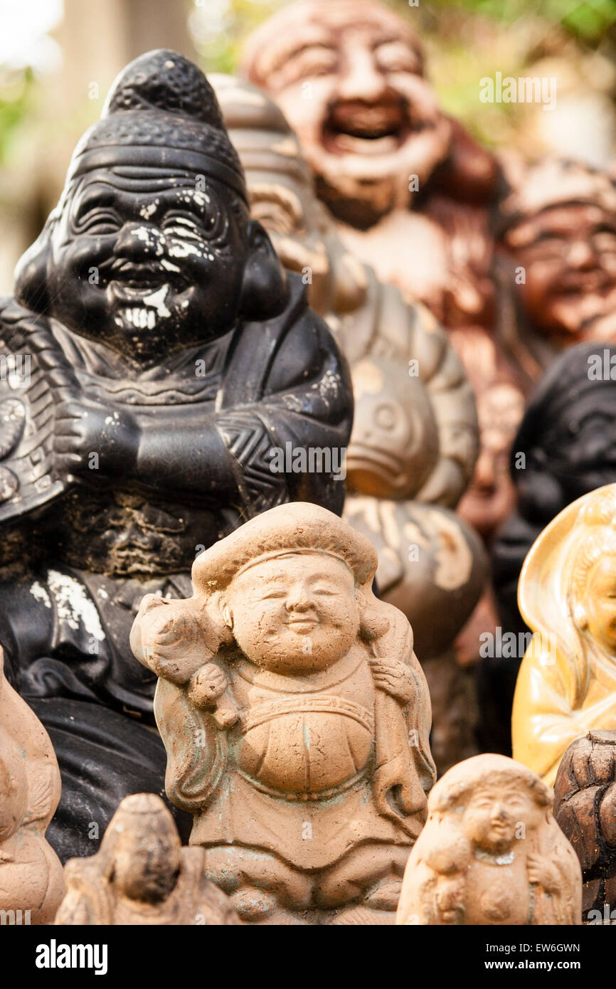 Japan, Kurashiki. Achi-jinja. Small statues of Shichifukujin, some of the the Japanese seven gods of happiness and good fortune arranged in group. Stock Photo