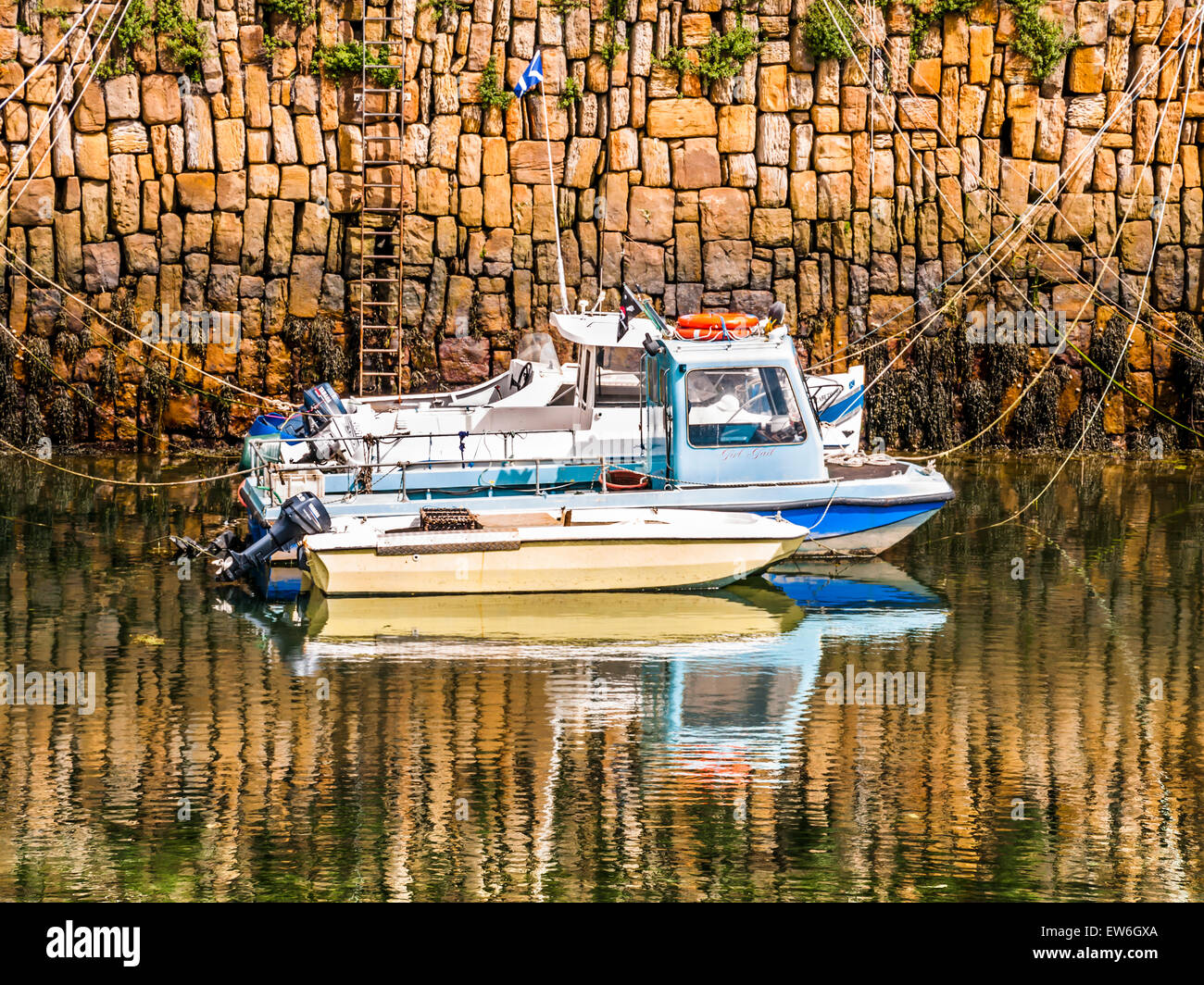 reflected mooring of two boats in quay in Ireland. Stock Photo