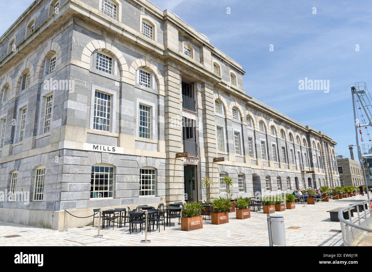 Flower planters and tables and chairs outside Prezzo restaurant in Royal William Yard, Plymouth Stock Photo