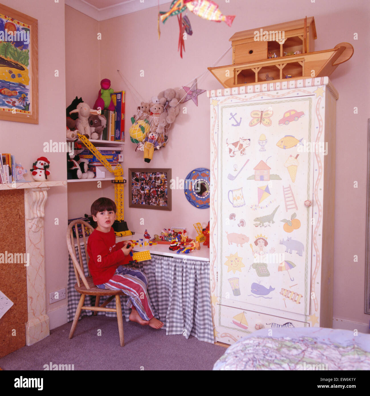 Portrait Of A Small Boy Playing With Lego In His Bedroom
