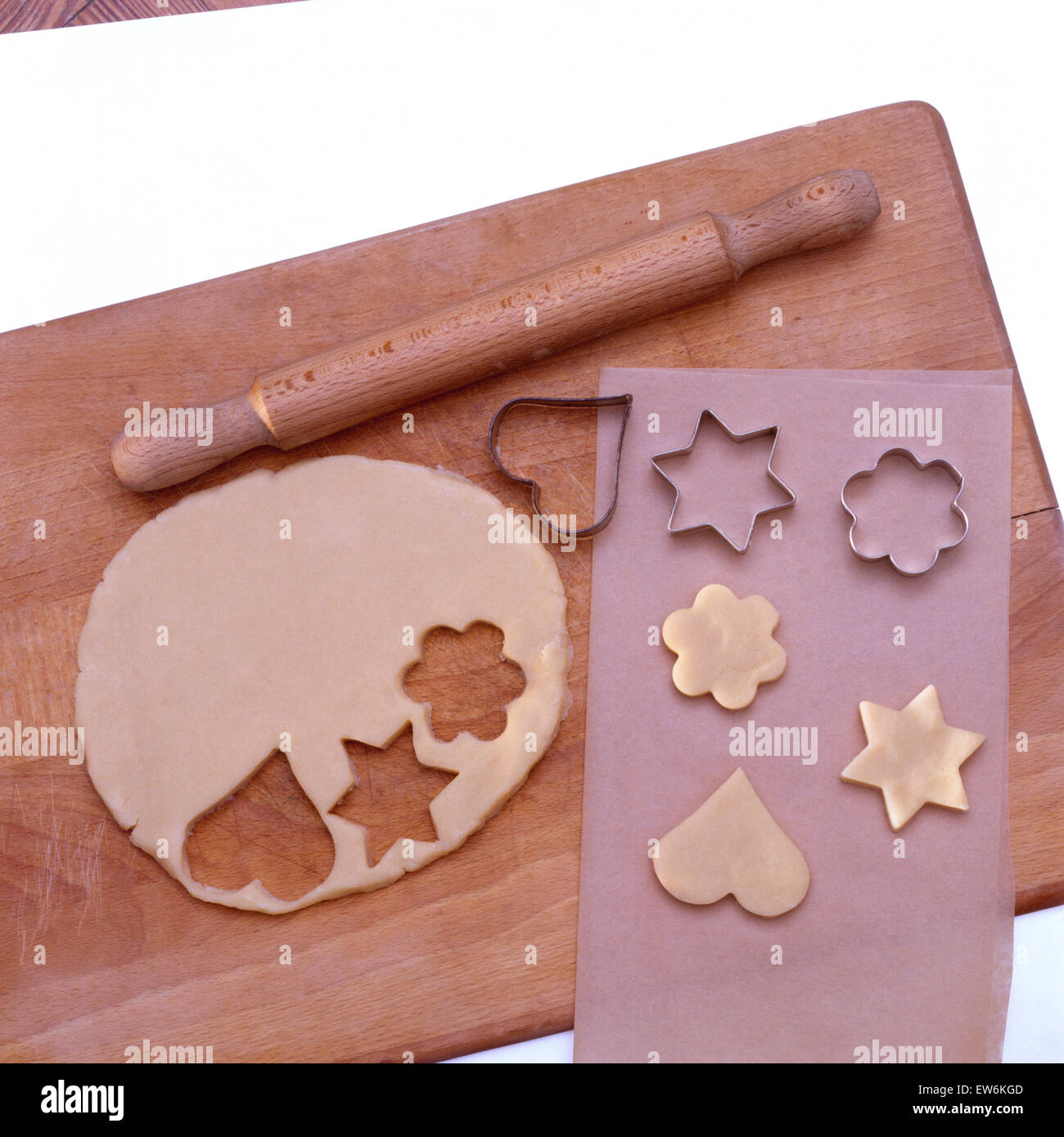 Close-up of home made biscuit dough with pastry cutters and a rolling pin Stock Photo