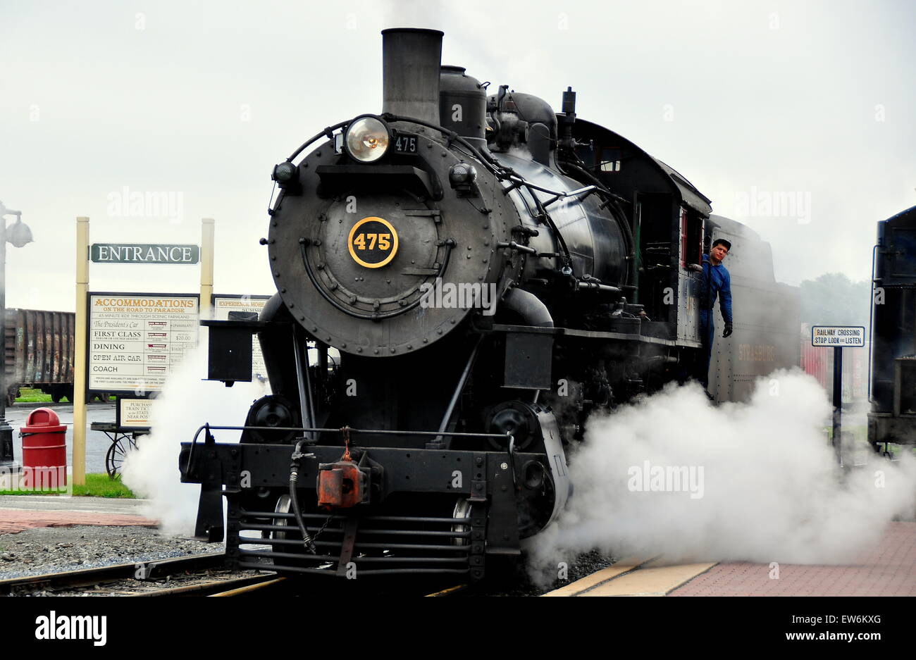 Strasburg, Pennsylvania:  A vintage steam locomotive with its engineer pulling into the Strasburg Railroad station  * Stock Photo