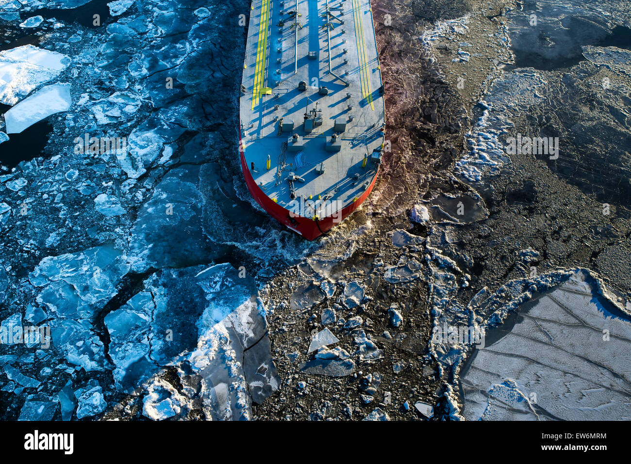 A large ship sails up a frozen river Stock Photo
