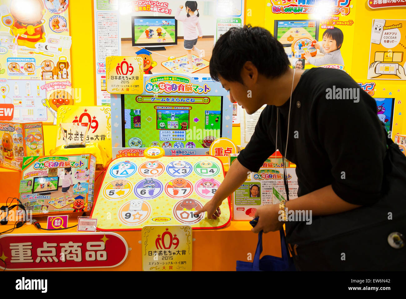 A man tries the products of JoyPalette Co., LTD. during the International Tokyo Toy Show 2015 in Tokyo Big Sight on June 18, 2015, Tokyo, Japan. Japan's largest trade show for toy makers attracts buyers and collectors by introducing the latest products from different toymakers from Japan and overseas. The toy fair showcases about 35,000 toys from 149 domestic and foreign companies and is held over four days. © Rodrigo Reyes Marin/AFLO/Alamy Live News Stock Photo