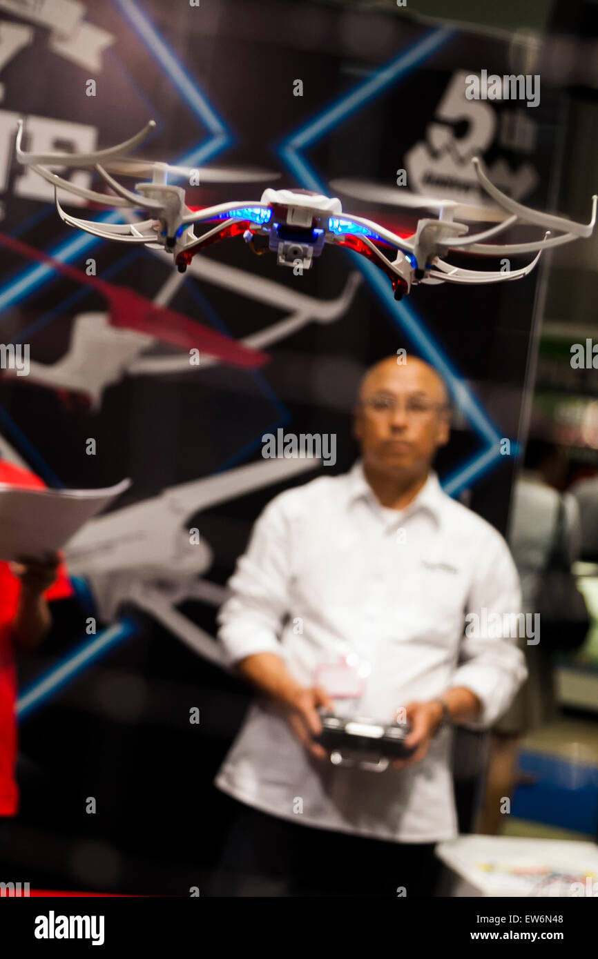 A man operates a toy drone at the International Tokyo Toy Show 2015 in Tokyo Big Sight on June 18, 2015, Tokyo, Japan. Japan's largest trade show for toy makers attracts buyers and collectors by introducing the latest products from different toymakers from Japan and overseas. The toy fair showcases about 35,000 toys from 149 domestic and foreign companies and is held over four days. © Rodrigo Reyes Marin/AFLO/Alamy Live News Stock Photo