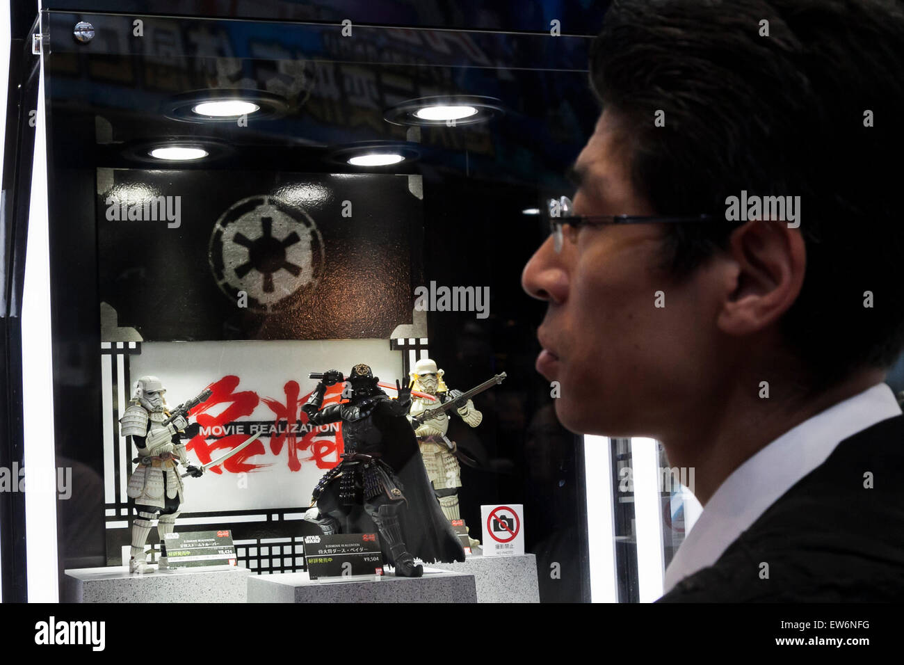 A man passes next to the action figures of Star Wars at the International Tokyo Toy Show 2015 in Tokyo Big Sight on June 18, 2015, Tokyo, Japan. Japan's largest trade show for toy makers attracts buyers and collectors by introducing the latest products from different toymakers from Japan and overseas. The toy fair showcases about 35,000 toys from 149 domestic and foreign companies and is held over four days. © Rodrigo Reyes Marin/AFLO/Alamy Live News Stock Photo