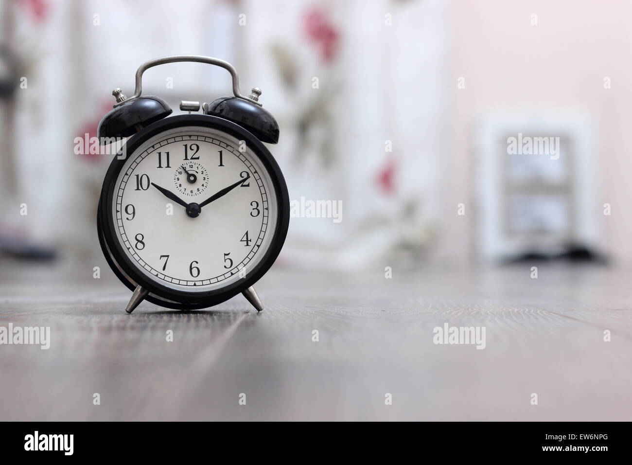 Vintage alarm clock on light background closeup Stock Photo - Alamy