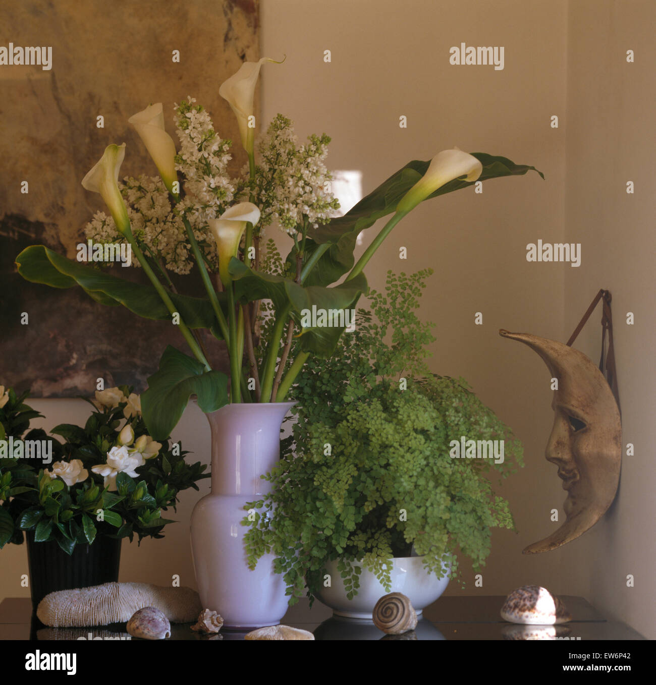 StillLife of arrangement of white lilies in vase beside a gardenia in