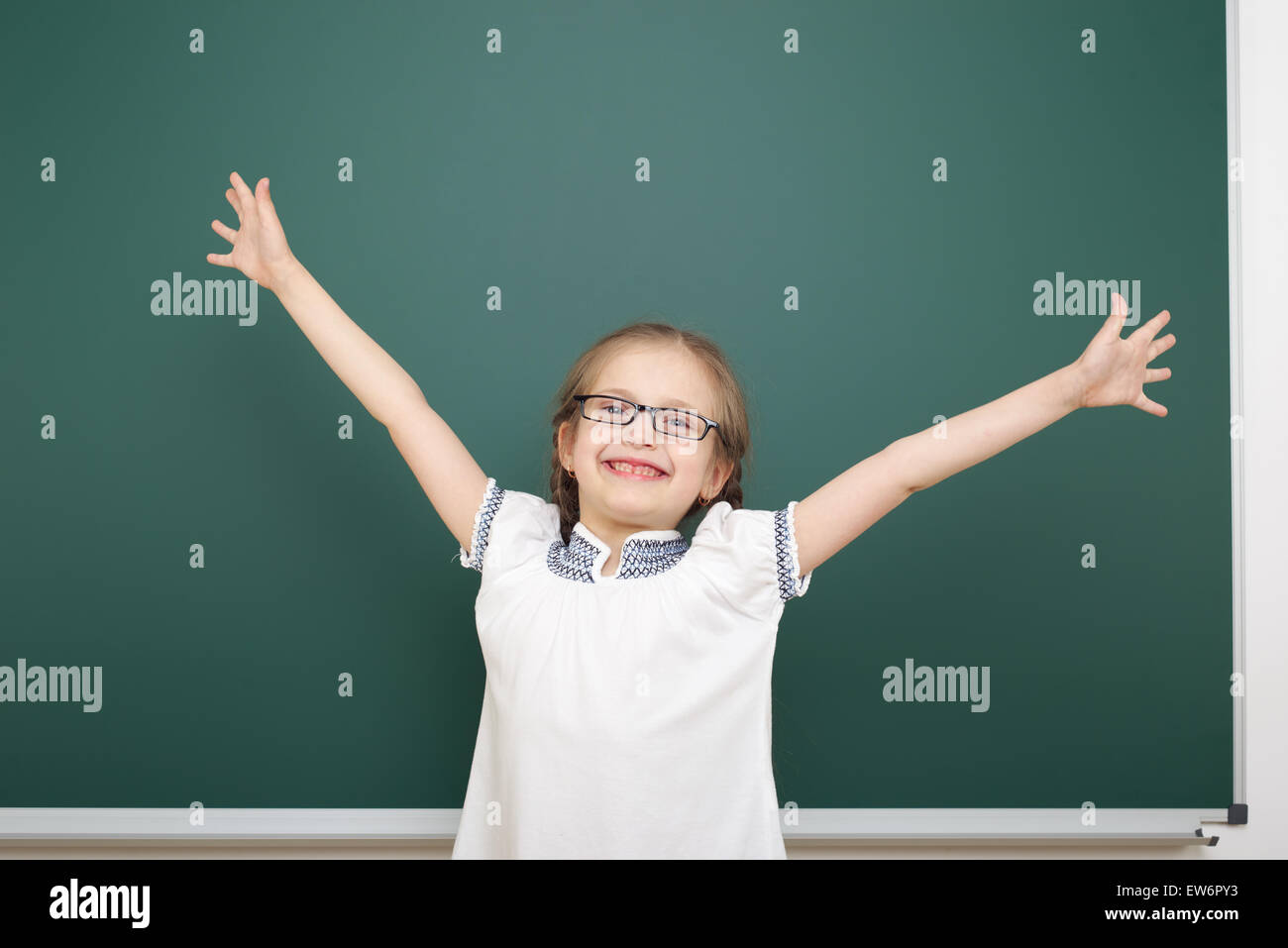 Schoolgirl near school board Stock Photo - Alamy
