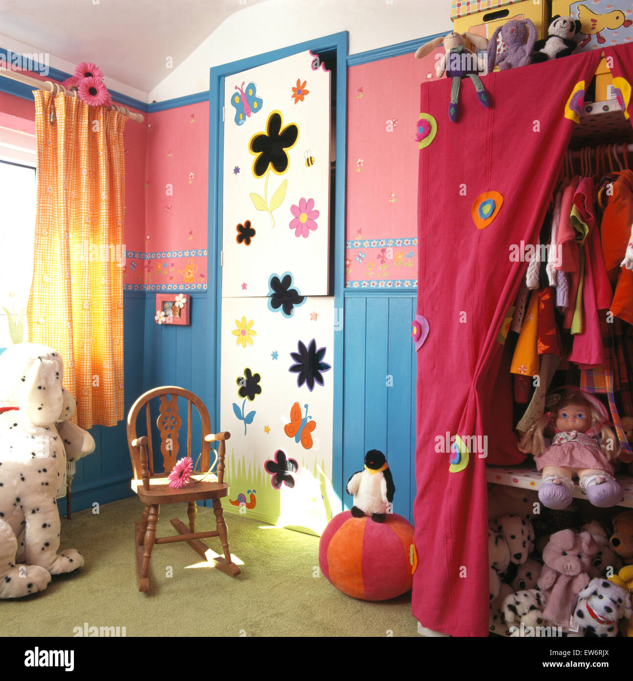 Floral painted cupboard doors in child's nineties bedroom with a pink canvas wardrobe Stock Photo
