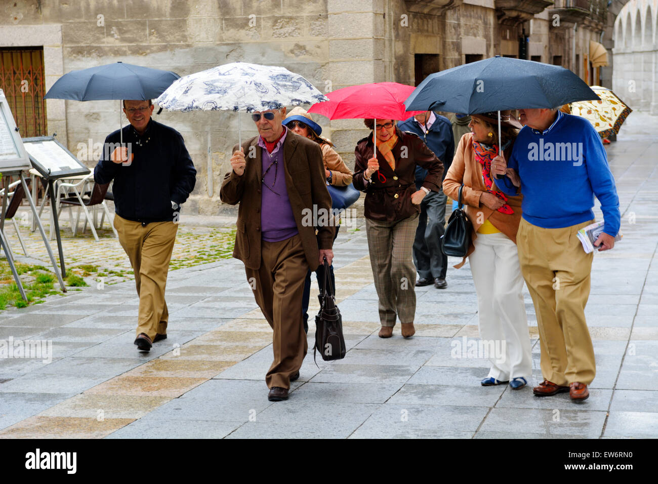 People walking with umbrellas in rain Stock Photo