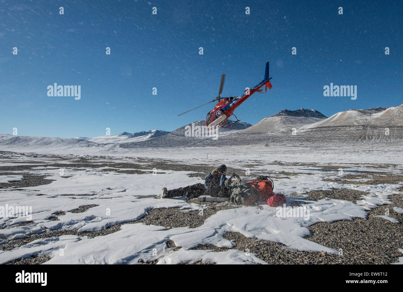 A scientific team is dropped off in the Victoria Valley, Antarctica. Stock Photo