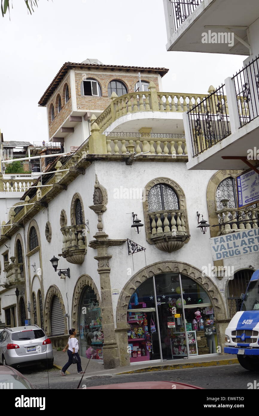 Woman walking toward a drug store entrance, downtown Puerto Vallarta, Mexico Stock Photo