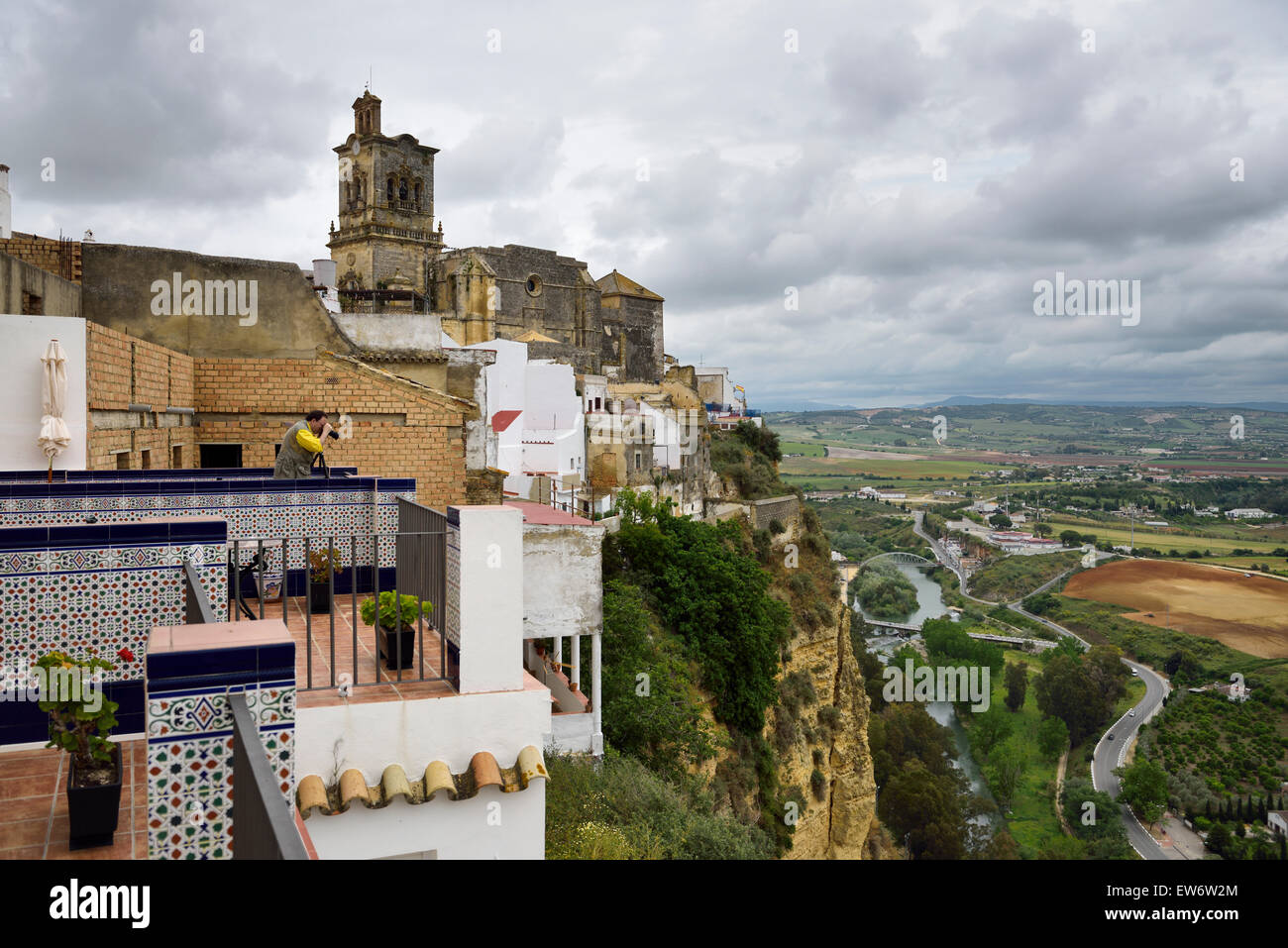 Photographer at Hotel el Convento Arcos de la Frontera with Guadalete river valley and Saint Peters church Stock Photo