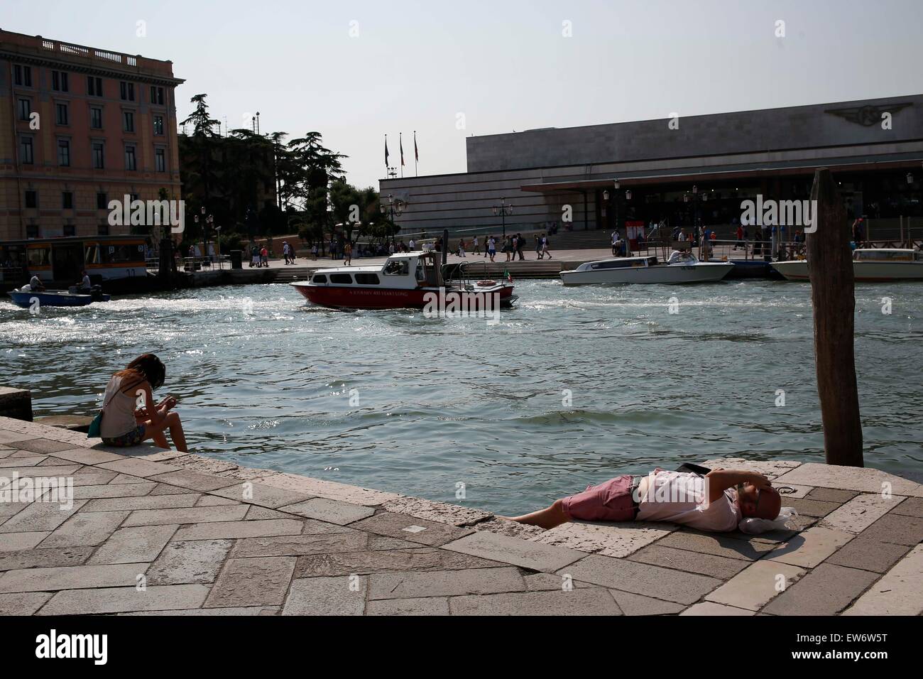 Tourist sunbathing in Venice Stock Photo