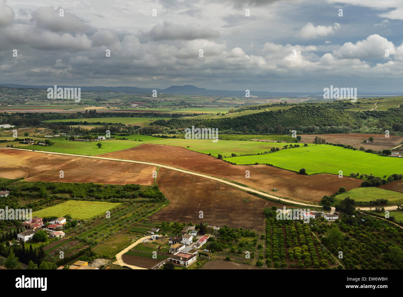 Sunlit farms and fields below Arcos de la Frontera Andalusia Spain Stock Photo