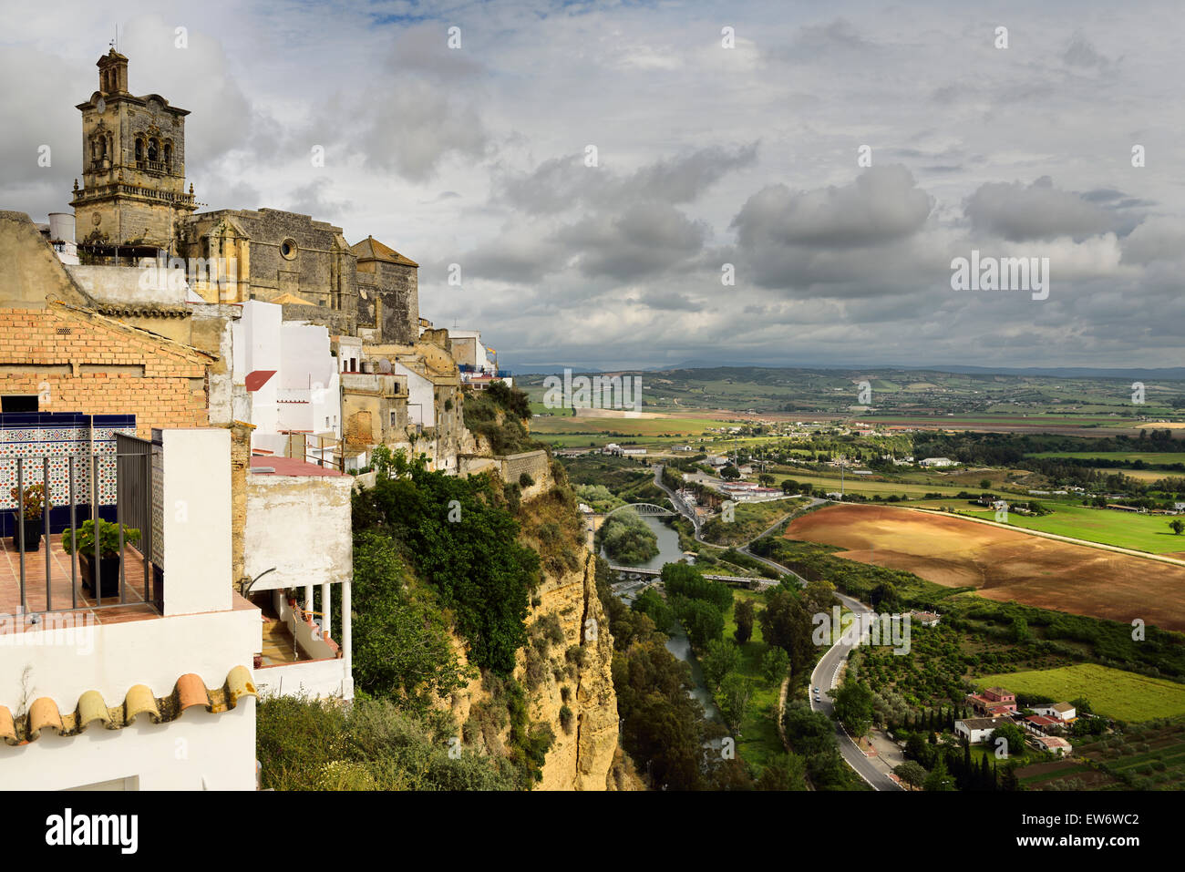 Cliffside terraces at Arcos de la Frontera with Guadalete river valley and 16th century church of Saint Peter Stock Photo