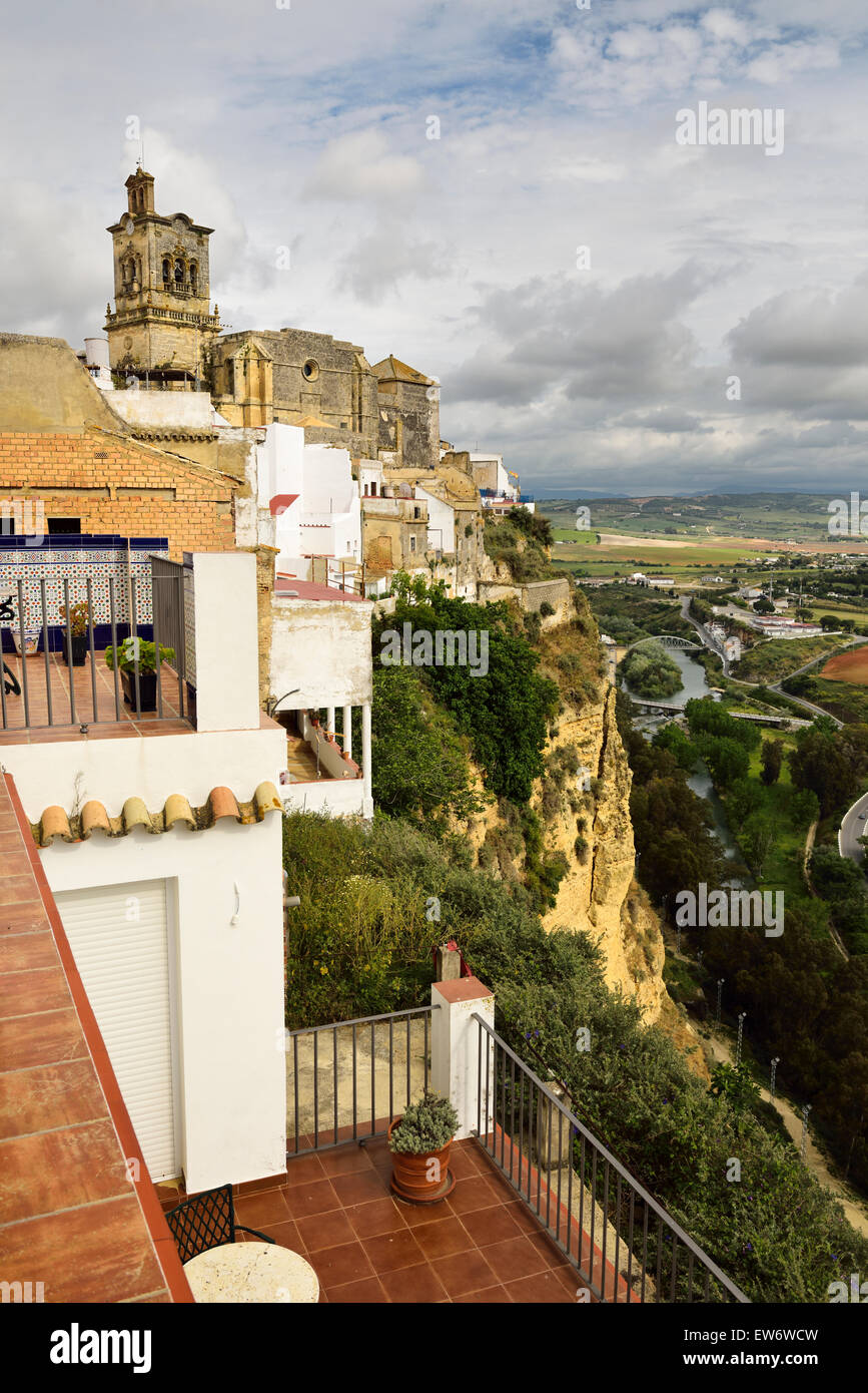 Hotel el Convento terraces at cliff of Arcos de la Frontera with Guadalete river valley and Saint Peter church Stock Photo