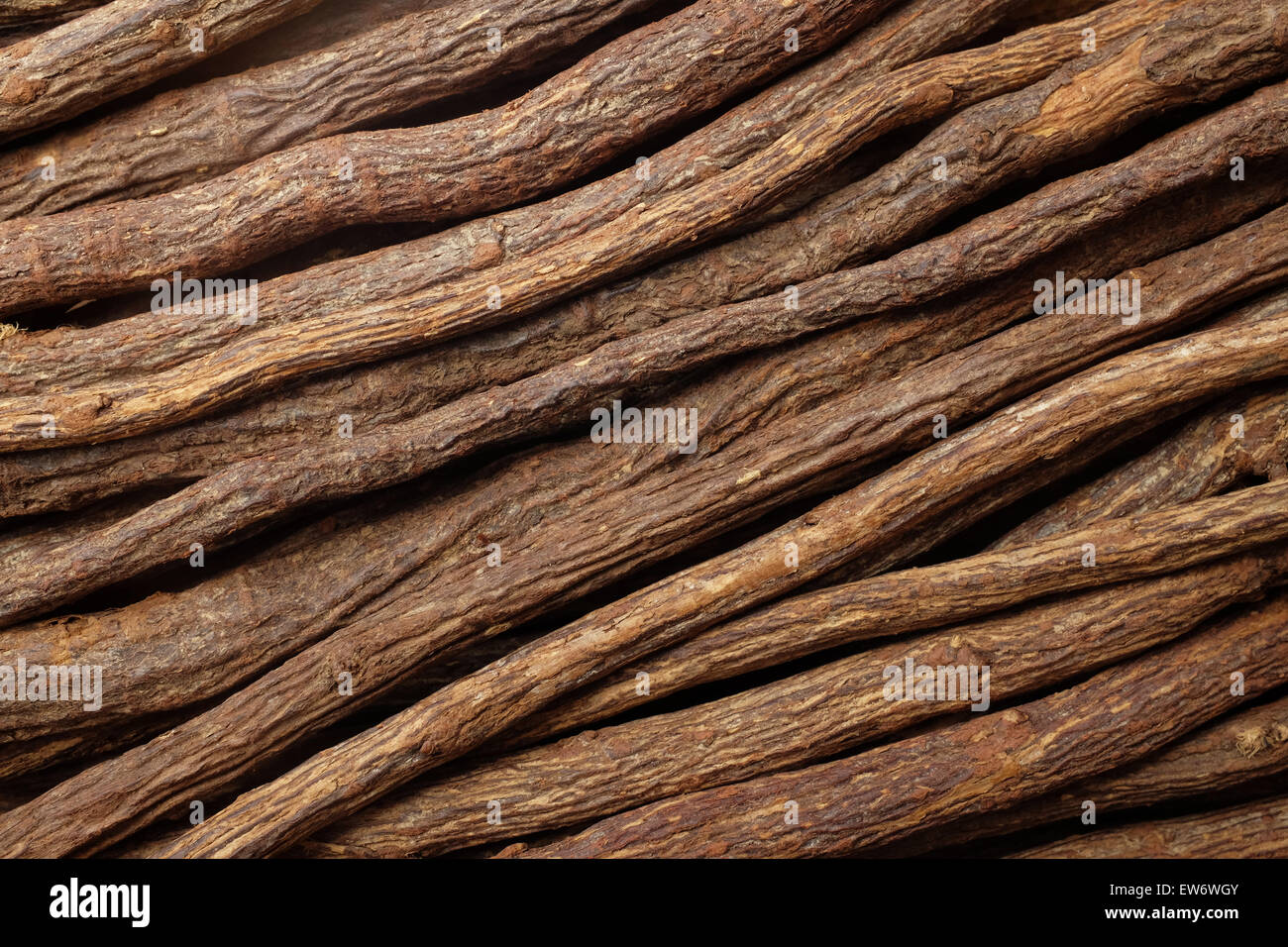 Pieces of liquorice root piled diagonally as an abstract background texture Stock Photo