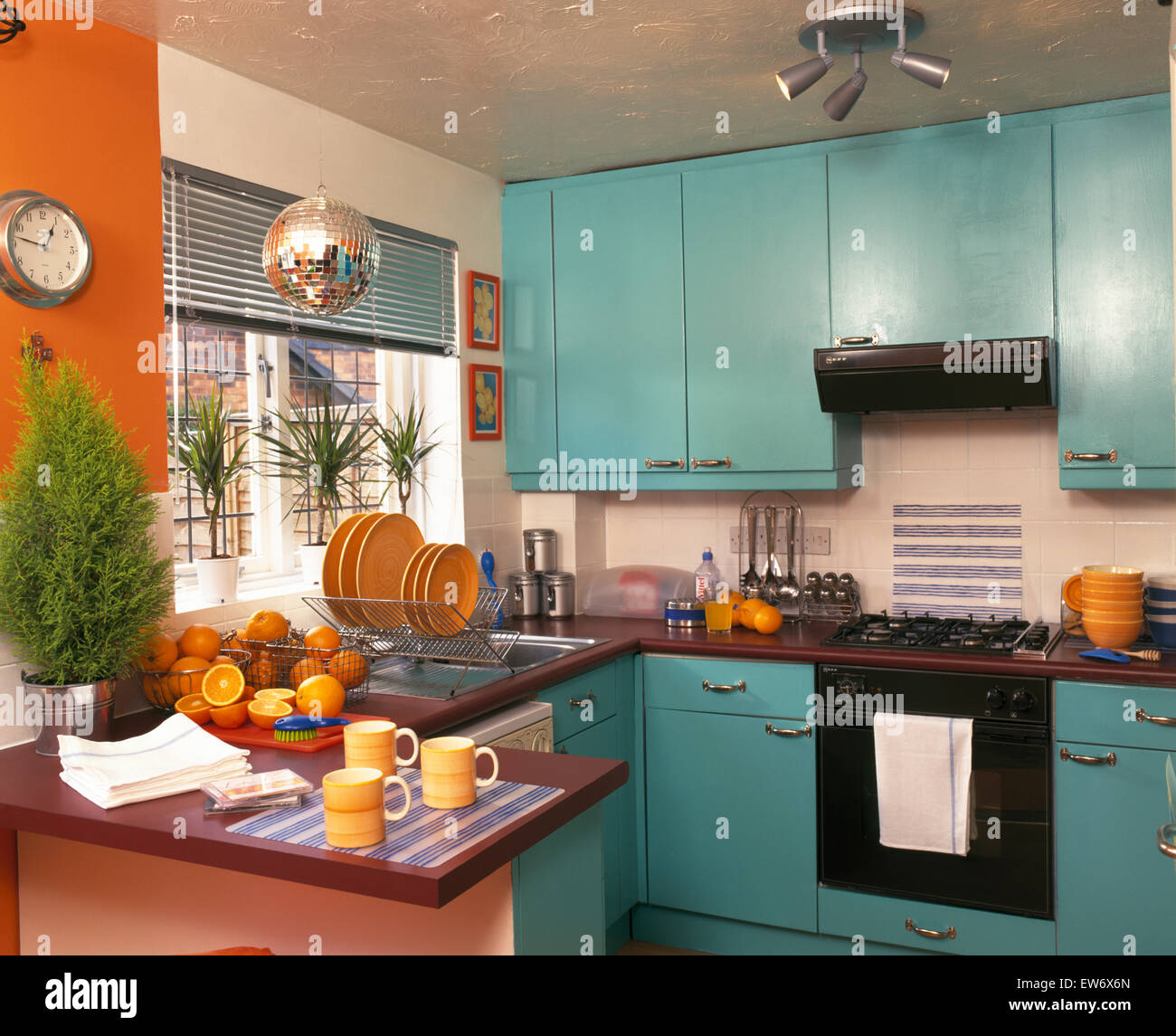 https://c8.alamy.com/comp/EW6X6N/yellow-crockery-in-nineties-economy-kitchen-with-turquoise-doors-on-EW6X6N.jpg