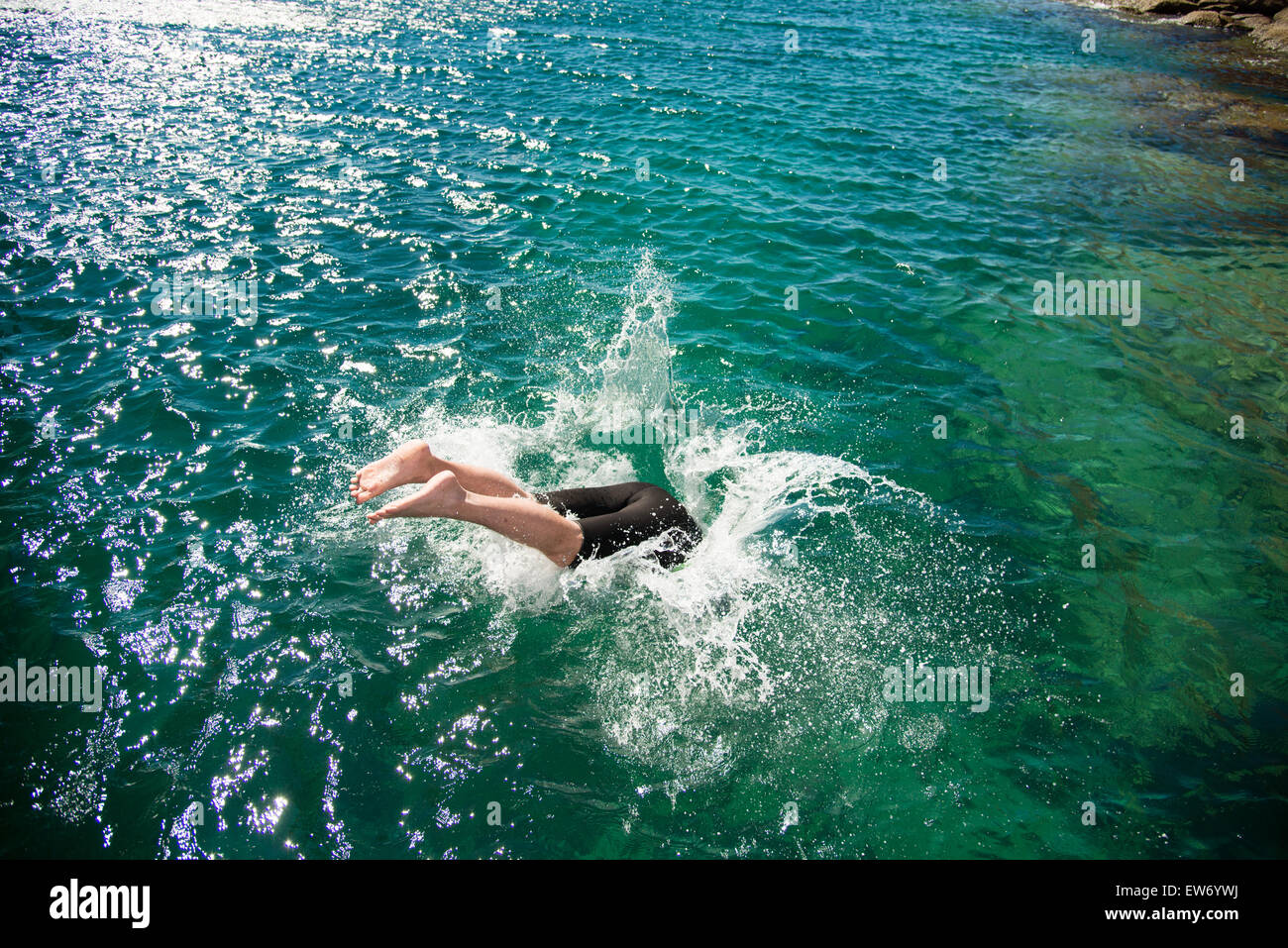 Mexico, Baja, Lapaz, Espiritu Santo. Tourists jumping into water. Stock Photo