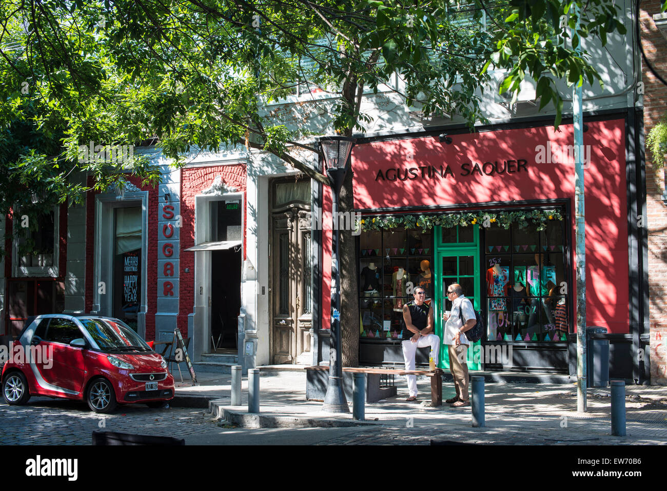 Men chatting outside restaurant, La Boca, Buenos Aires Stock Photo