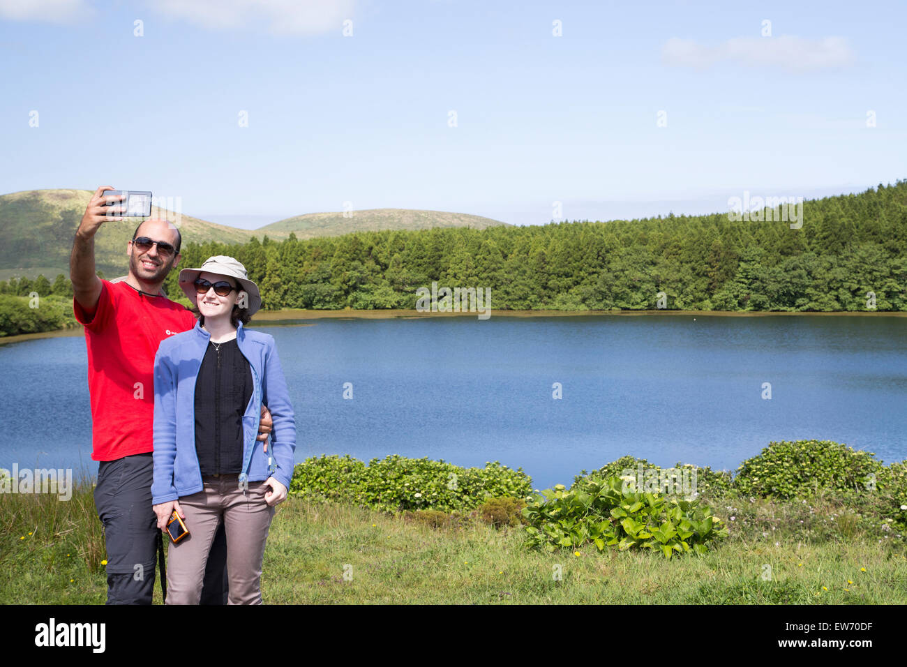 A couple of tourists taking a selfie image at one of the seven volcano lakes in Flores island. (This one is lake of Lomba) Stock Photo