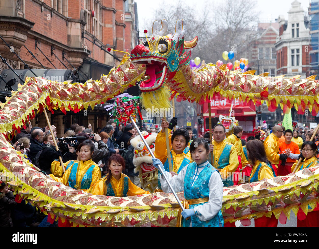 People wearing traditional Chinese costume celebrating Chinese New Year with a large paper Chinese Dragon Stock Photo