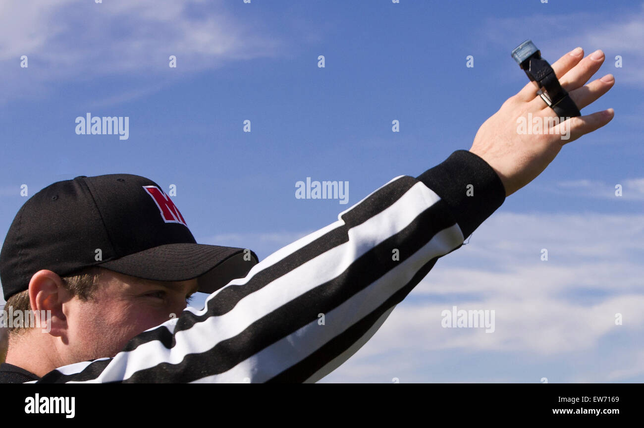 An official signaling at a football game Stock Photo