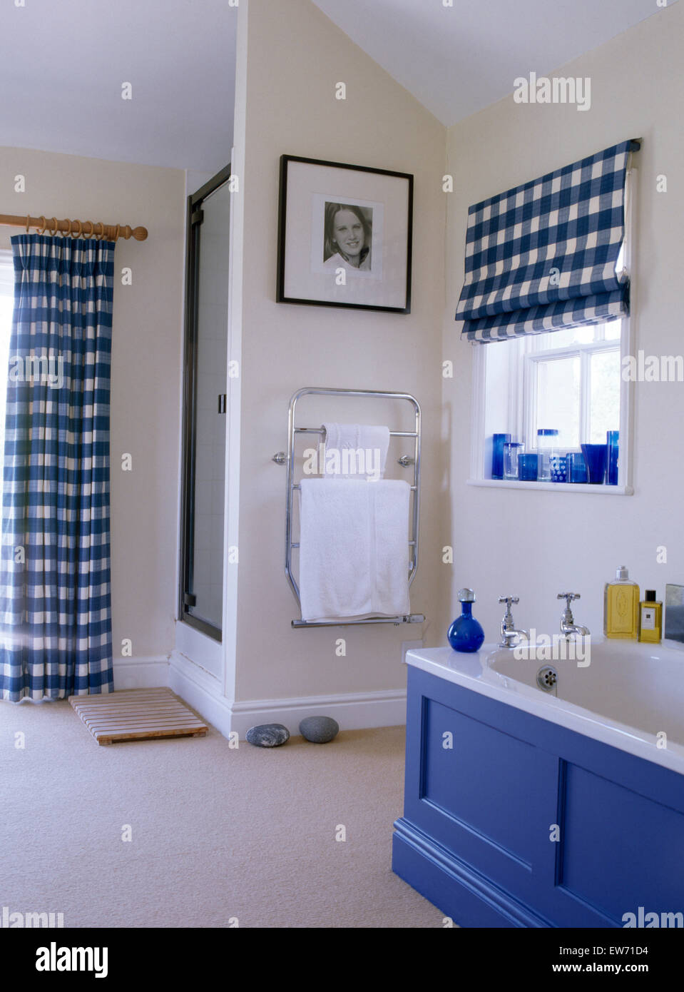 Blue checked blind and curtains in white cottage bathroom with blue